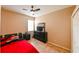 Small bedroom with a red bed, dark dresser, tiled floor, and a window at 20330 Natures Corner Dr, Tampa, FL 33647