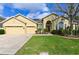 Charming single-story home featuring a well-manicured lawn and a three-car garage at 20330 Natures Corner Dr, Tampa, FL 33647