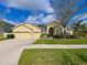 Charming single-story home featuring a well-manicured lawn and a three-car garage at 20330 Natures Corner Dr, Tampa, FL 33647