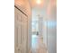 Hallway with tile flooring leading to the bathroom and additional rooms at 20330 Natures Corner Dr, Tampa, FL 33647