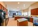 Bright, open kitchen featuring wooden cabinets, black appliances, and a view to the living room at 20330 Natures Corner Dr, Tampa, FL 33647