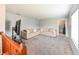 Bright living room featuring neutral decor, plush carpeting, and comfortable seating arrangement at 20330 Natures Corner Dr, Tampa, FL 33647