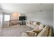 Carpeted loft-style living room featuring neutral sofas and a large window at 20330 Natures Corner Dr, Tampa, FL 33647