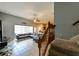 The living room with tile flooring, a dark sofa and a staircase with wooden railings at 20330 Natures Corner Dr, Tampa, FL 33647