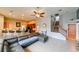 An open concept living room with a kitchen bar, dark sofa, stairs and recessed lighting at 20330 Natures Corner Dr, Tampa, FL 33647