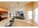 Open concept living room with a large kitchen island and ample natural light at 20330 Natures Corner Dr, Tampa, FL 33647