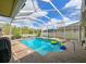 Sparkling backyard pool featuring a screened enclosure, spa, and spacious brick patio at 20330 Natures Corner Dr, Tampa, FL 33647
