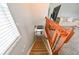 Carpeted stairs with wooden railings, providing a safe and stylish transition between floors at 20330 Natures Corner Dr, Tampa, FL 33647