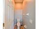 Small half bathroom with toilet and wall-mounted accessories at 20330 Natures Corner Dr, Tampa, FL 33647
