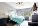 Cozy bedroom featuring a large window, comfortable bed with blue comforter, and modern decor at 2352 Lake Woodberry Cir, Brandon, FL 33510