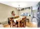 Dining room featuring a chandelier, wooden table, and an open view to the kitchen at 2352 Lake Woodberry Cir, Brandon, FL 33510