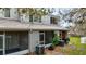 Townhome patio and yard with mature trees and a screened-in lanai at 2352 Lake Woodberry Cir, Brandon, FL 33510