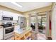 Well-equipped kitchen with stainless steel appliances, a movable island, and access to a screened patio for seamless indoor-outdoor living at 2352 Lake Woodberry Cir, Brandon, FL 33510