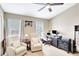 Comfortable office space with two chairs, a desk, and natural light from the windows at 2352 Lake Woodberry Cir, Brandon, FL 33510
