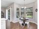 A breakfast nook featuring a round table, white chairs, and views of the backyard at 2412 Gallagher Rd, Dover, FL 33527