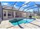 In-ground pool and rear exterior of home with covered patio and lanai at 2412 Gallagher Rd, Dover, FL 33527