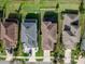 Top-down aerial view of neatly arranged homes, green lawns, driveways, and neighborhood streets at 29011 Trevi Pl, Wesley Chapel, FL 33543
