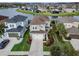Aerial view of a home with manicured lawn, and a nearby lake at 29011 Trevi Pl, Wesley Chapel, FL 33543
