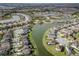 Wide aerial shot showcasing homes in a lakeside community with tree-lined streets and neighborhood amenities at 29011 Trevi Pl, Wesley Chapel, FL 33543