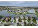 Wide aerial perspective of a neighborhood nestled among winding lakes, featuring well-maintained homes at 29011 Trevi Pl, Wesley Chapel, FL 33543