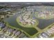 Scenic aerial shot of a residential neighborhood featuring winding roads and picturesque lakes at 29011 Trevi Pl, Wesley Chapel, FL 33543