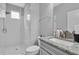 Modern bathroom with a glass-enclosed shower, granite countertop, and white fixtures at 29011 Trevi Pl, Wesley Chapel, FL 33543