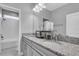Modern bathroom featuring a granite dual sink countertop at 29011 Trevi Pl, Wesley Chapel, FL 33543
