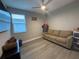 Well-lit bedroom with stylish furniture, a comfortable couch, and laminate flooring throughout at 29011 Trevi Pl, Wesley Chapel, FL 33543
