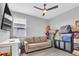 Spare bedroom with sofa, ceiling fan, and window at 29011 Trevi Pl, Wesley Chapel, FL 33543