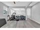 Open-concept bonus room area with home gym, archway, and hardwood floors at 29011 Trevi Pl, Wesley Chapel, FL 33543