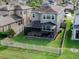 Aerial view of the back of the house highlighting a fenced backyard, patio, and lush greenery at 29011 Trevi Pl, Wesley Chapel, FL 33543