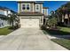 Charming two-story home with a well-manicured lawn, features a two-car garage and elegant landscaping at 29011 Trevi Pl, Wesley Chapel, FL 33543