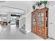 Bright and spacious foyer with a staircase and an elegant wooden cabinet display at 29011 Trevi Pl, Wesley Chapel, FL 33543