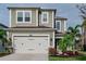Charming two-story home featuring a two-car garage, landscaped front yard, and neutral stucco exterior at 29011 Trevi Pl, Wesley Chapel, FL 33543
