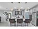 Updated kitchen with stainless appliances, kitchen island with bar stool seating, and pantry at 29011 Trevi Pl, Wesley Chapel, FL 33543