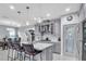 Updated kitchen with stainless appliances, kitchen island with bar stool seating, and pantry at 29011 Trevi Pl, Wesley Chapel, FL 33543