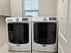 Bright laundry room featuring a Maytag washer and dryer, complete with built in cabinetry and a window at 29011 Trevi Pl, Wesley Chapel, FL 33543