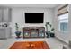 Living room featuring a large TV, fireplace, and wood entertainment center at 29011 Trevi Pl, Wesley Chapel, FL 33543