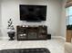 The living room features a large entertainment center, tile flooring, and a mounted television at 29011 Trevi Pl, Wesley Chapel, FL 33543