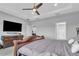 The main bedroom features an ensuite bath and a flat-screen television at 29011 Trevi Pl, Wesley Chapel, FL 33543