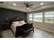 Spacious main bedroom suite with a decorative ceiling, waterfront views from the windows, and laminate flooring at 29011 Trevi Pl, Wesley Chapel, FL 33543