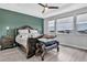 Main bedroom featuring a decorative wood bed frame, tray ceiling, and many windows at 29011 Trevi Pl, Wesley Chapel, FL 33543
