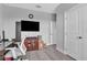 Well-lit home office with wood-look floors and a large-screen television at 29011 Trevi Pl, Wesley Chapel, FL 33543