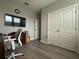 Office space showing the door access, flooring and wall colors, as well as a large wall mounted TV at 29011 Trevi Pl, Wesley Chapel, FL 33543