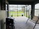 Enjoy outdoor living with this screened patio, barbecue, swing, and a serene view of the lake at 29011 Trevi Pl, Wesley Chapel, FL 33543