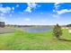 Expansive backyard featuring a tranquil lake providing picturesque views and serene outdoor living at 3027 Marine Grass Dr, Wimauma, FL 33598