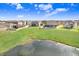 Scenic backyard backing onto a pond, showcasing lush greenery and serene water views in a neighborhood at 3027 Marine Grass Dr, Wimauma, FL 33598