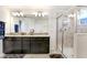 Stylish bathroom featuring dual sinks, granite countertops, and a walk-in shower at 3027 Marine Grass Dr, Wimauma, FL 33598