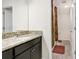 Modern bathroom featuring granite counters, dark wood cabinets and shower with decorative curtain at 3027 Marine Grass Dr, Wimauma, FL 33598