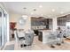 Bright kitchen features a large island, stainless steel appliances, and dining area at 3027 Marine Grass Dr, Wimauma, FL 33598
